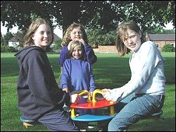   two children on play equipment  